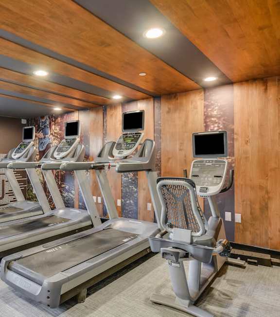 A gym with treadmills and a sign that says  at Nobel Court, San Diego