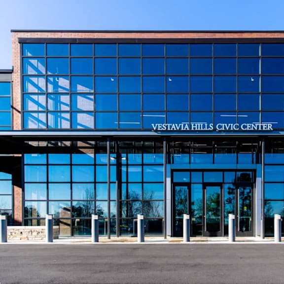 The Vestavia Hills Civic Center is a large, modern building with a glass facade.