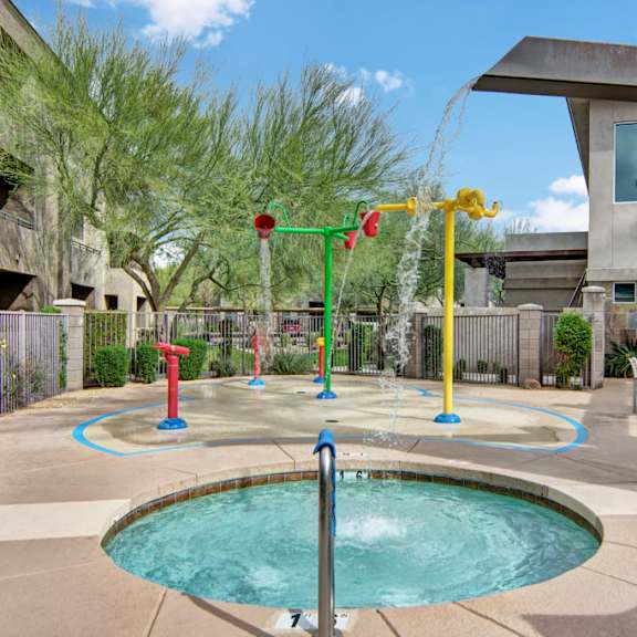 A hot tub with a water play area, including water cascading into the pool at Aspire Pinnacle Peak. 