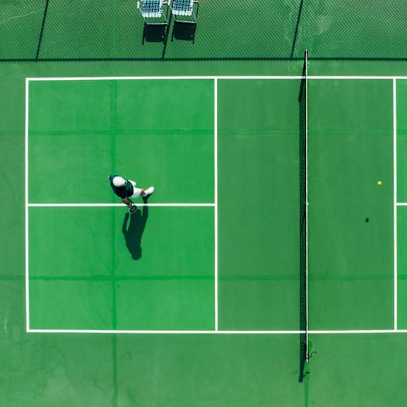 Two tennis players on a green court.