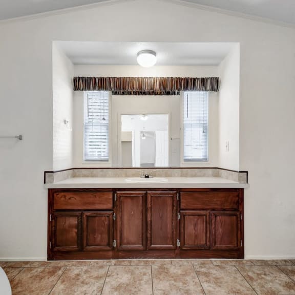a bathroom with a sink and a toilet at Buckingham Village in Universal City, TX