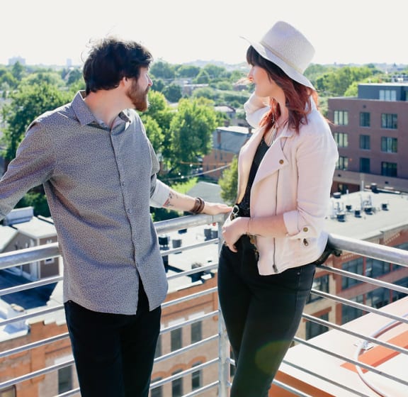 A couple enjoying the rooftop patio over looking the short north at 985 High