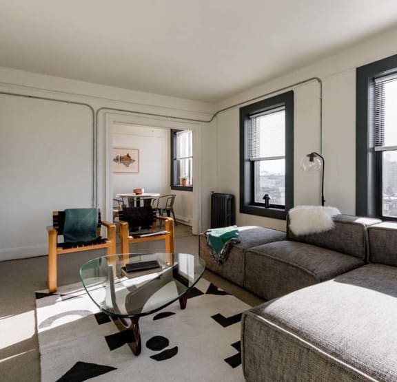 a bedroom with a bed and bookshelves     and a chair