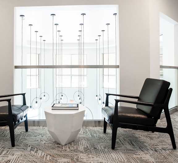 a courtyard with tables and chairs at night at 401 Oberlin, Raleigh, 27605