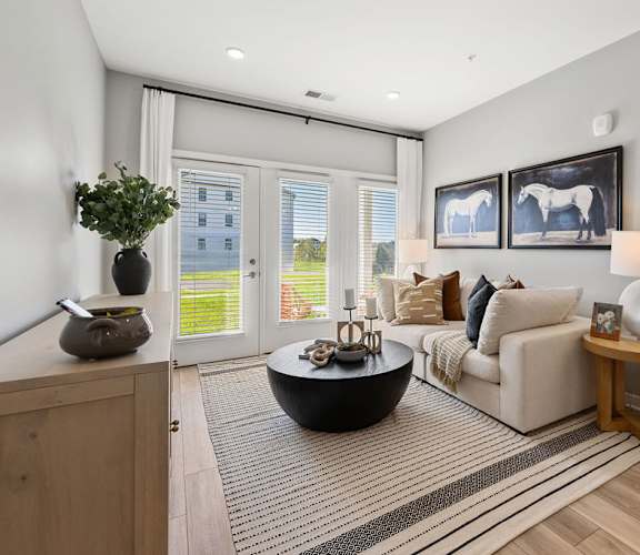 A modern living room with a large window and a view of a building outside at Madison Prickett Preserve, Yardley Pennsylvania