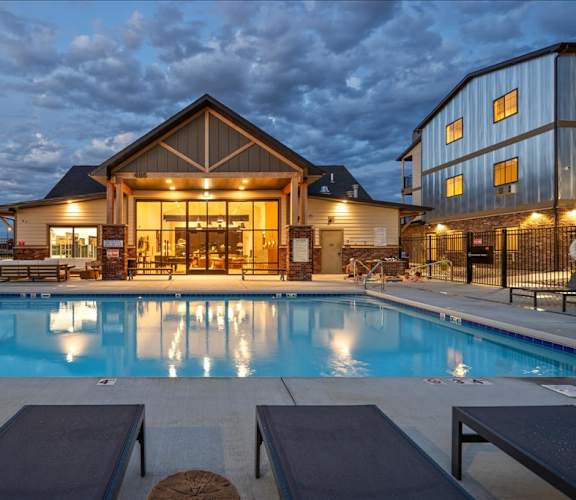 A large house with a pool in front of it.