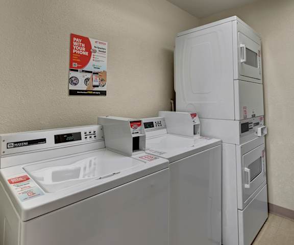The laundry room with washers and dryers at the Legacy Apartment Homes. 