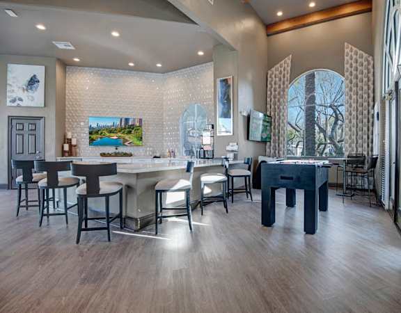 A modern dining room with a large table and chairs.