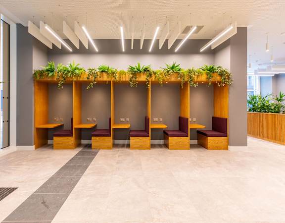 a large lobby with benches and plants