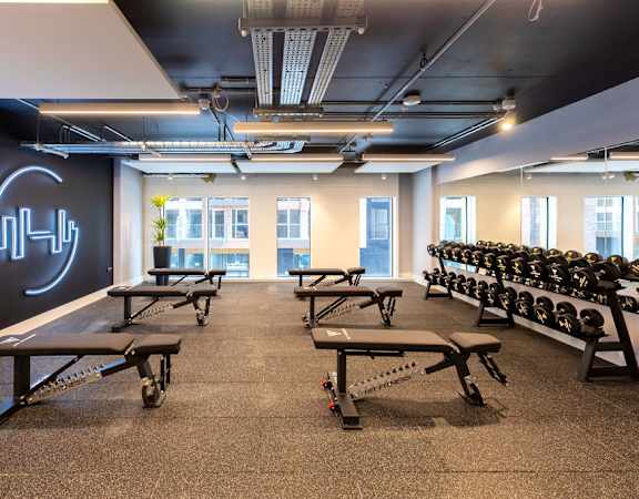 a large room filled with benches and yoga chars