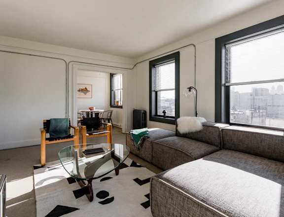 a living room with a couch and a glass table