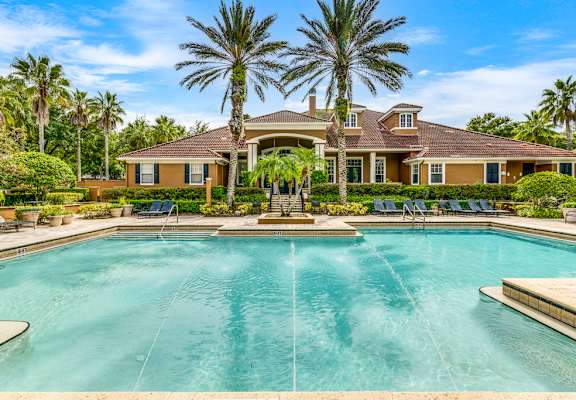 A large house with a pool in front of it.
