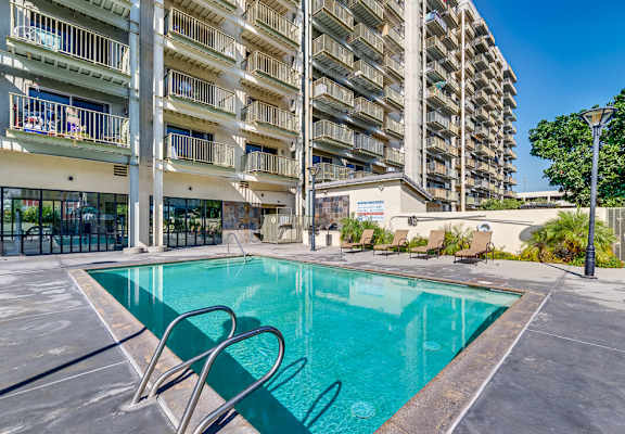 a swimming pool in front of an apartment building
