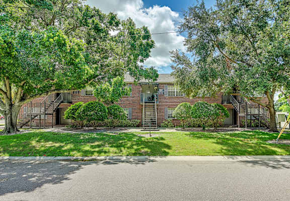 A house with a driveway and trees in front. at Green Oaks Apartments, Florida, 33616