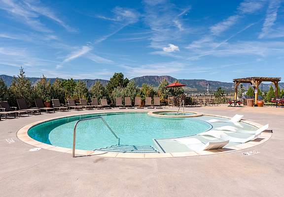 A large outdoor pool with a spa and a mountain view at Vistas at Jackson Creek, Colorado