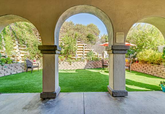 Patio with a stone archway at Azure Point at Encinitas - 55+ Active Adult Apartments, Encinitas, CA