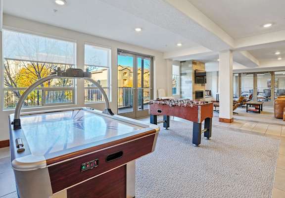 a game room with a pool table and a foosball
