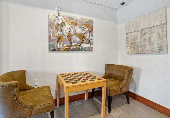 a game room with a chess board and chairs