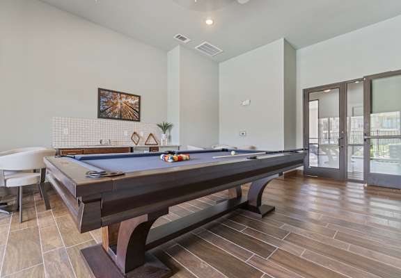 Clubhouse game room with pool table at Auberge of Tyler luxury apartments in Tyler TX.