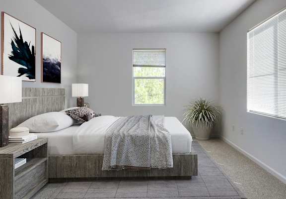 a bedroom with a bed and two windows