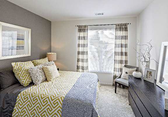 a bedroom with a bed and a window at Merion Stratford Apartment Homes, Stratford