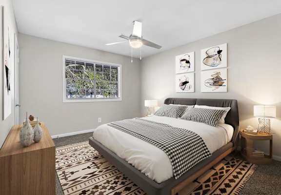 a bedroom with a bed and a ceiling fan