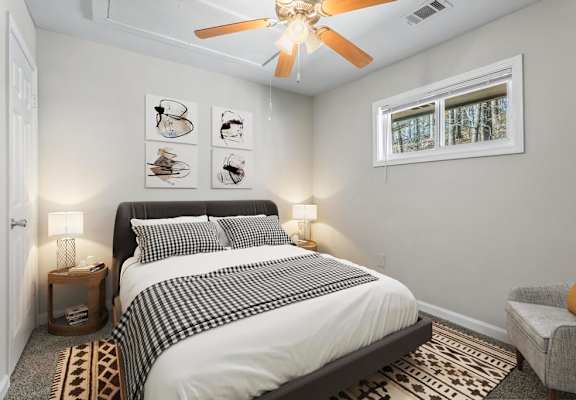 a bedroom with a bed and a ceiling fan