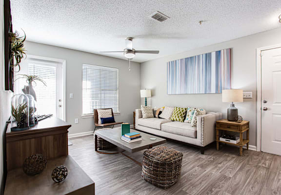a living room with a couch and a coffee table  at Peaks at Gainesville, Gainesville, GA