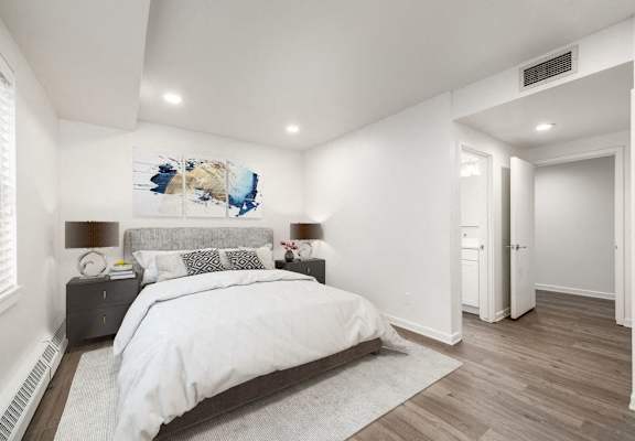 Bedroom with hardwood flooring and white walls