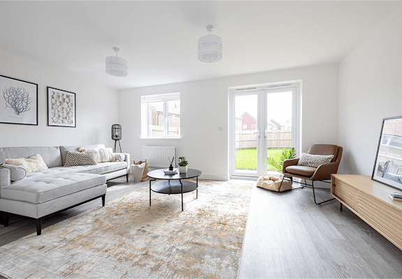 A living room with a grey sofa, a coffee table, and a chair.