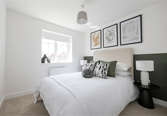 A bedroom with a large bed and a window.