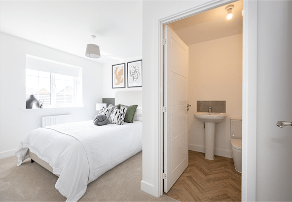 a bedroom with a bed and a toilet and a bathroom