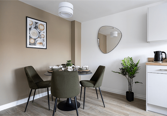 a dining room with a table and chairs and a mirror
