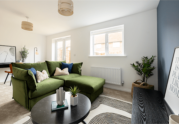 a living room with a green couch and a coffee table