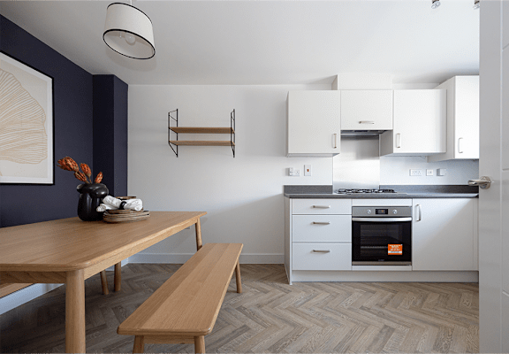 A kitchen with a wooden table and bench.