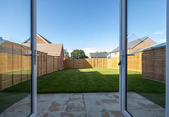 A view of a backyard through a glass door.