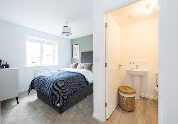 a bedroom with a bed and a sink and a mirror