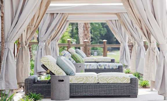 a gazebo with couches and pillows on a patio at Wharf 7 Apartments, South Carolina, 29492