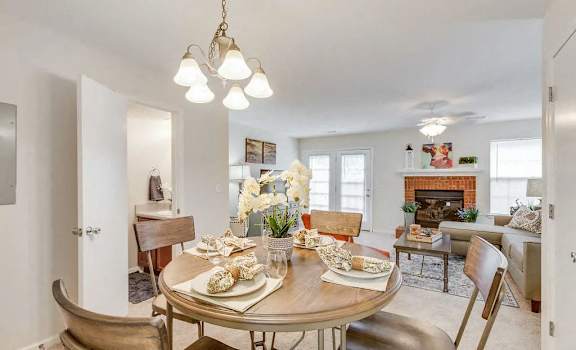 A dining room with a table set for a meal.