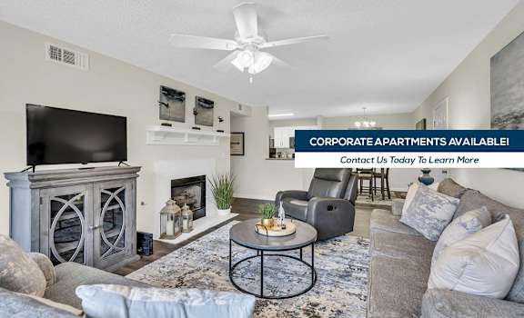 A living room with a fireplace and a television on the wall.
