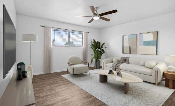 a living room with a couch and a ceiling fan