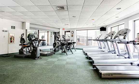 a large fitness room with treadmills and elliptical trainers at Lory of Harbison, Columbia