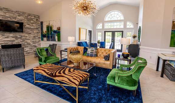 A living room with a zebra print rug and a gold and blue sofa.