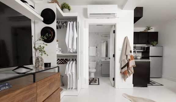 A modern kitchen with a wooden countertop and a black stove top.