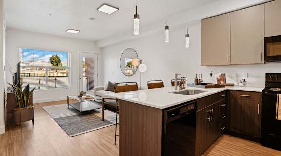 a kitchen with an island and a living room with a couch and a coffee table