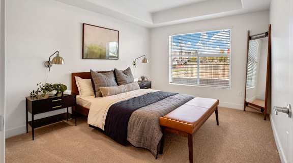 a bedroom with a large bed and a large window