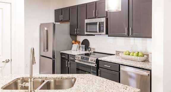 Spacious Modern Kitchen with Breakfast Bar and Wood Cabinetry