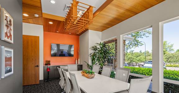 A conference room with a long table and chairs.