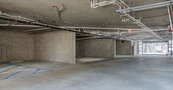 A large, empty parking garage with concrete floors and walls.