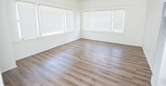A room with wooden floors and white walls.